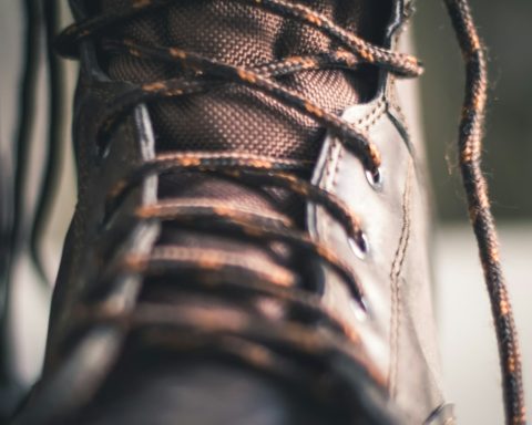 person wearing brown and black hiking shoe