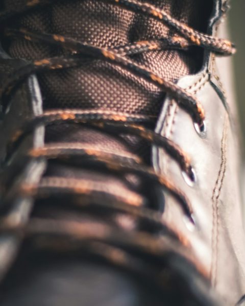 person wearing brown and black hiking shoe