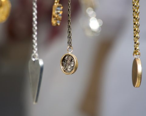 gold-and-silver-colored pendant necklace