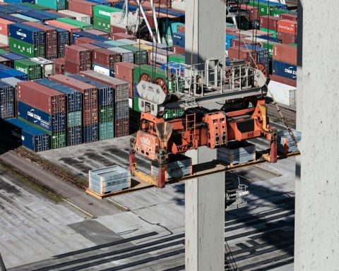 an overhead view of cargo containers and a crane