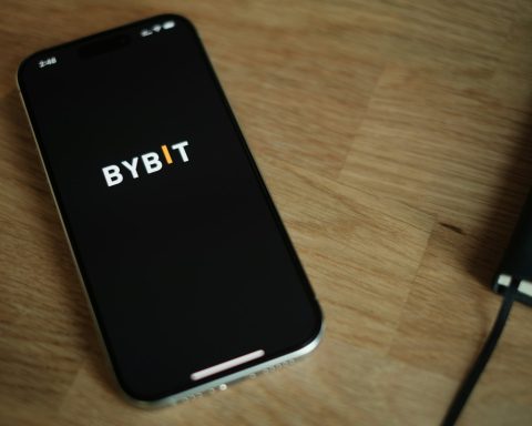 A cell phone sitting on top of a wooden table