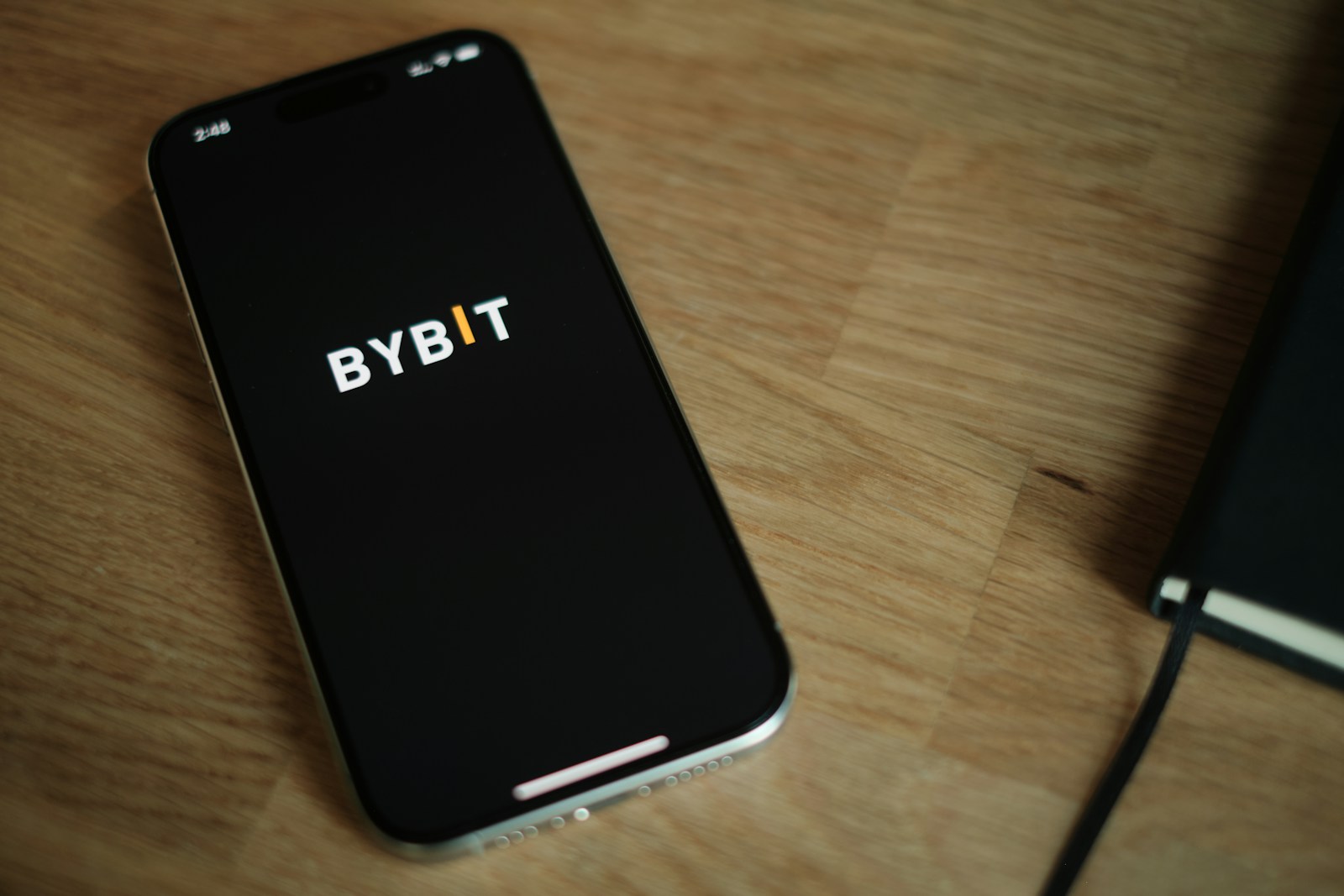 A cell phone sitting on top of a wooden table