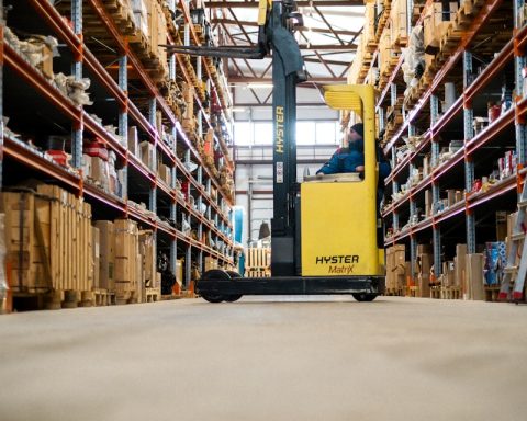 A yellow forklift in a large warehouse