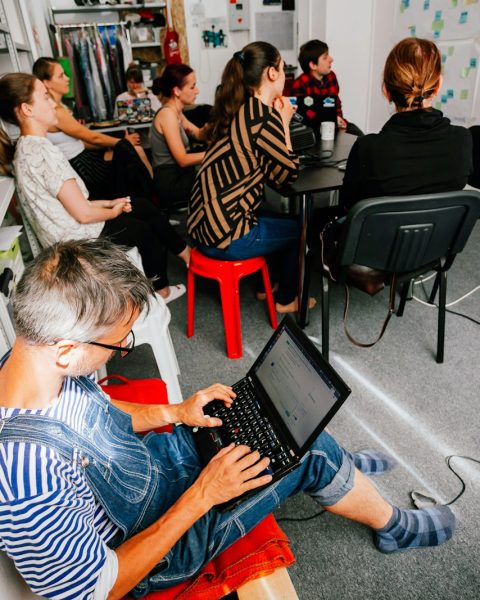 a man sitting in front of a laptop computer