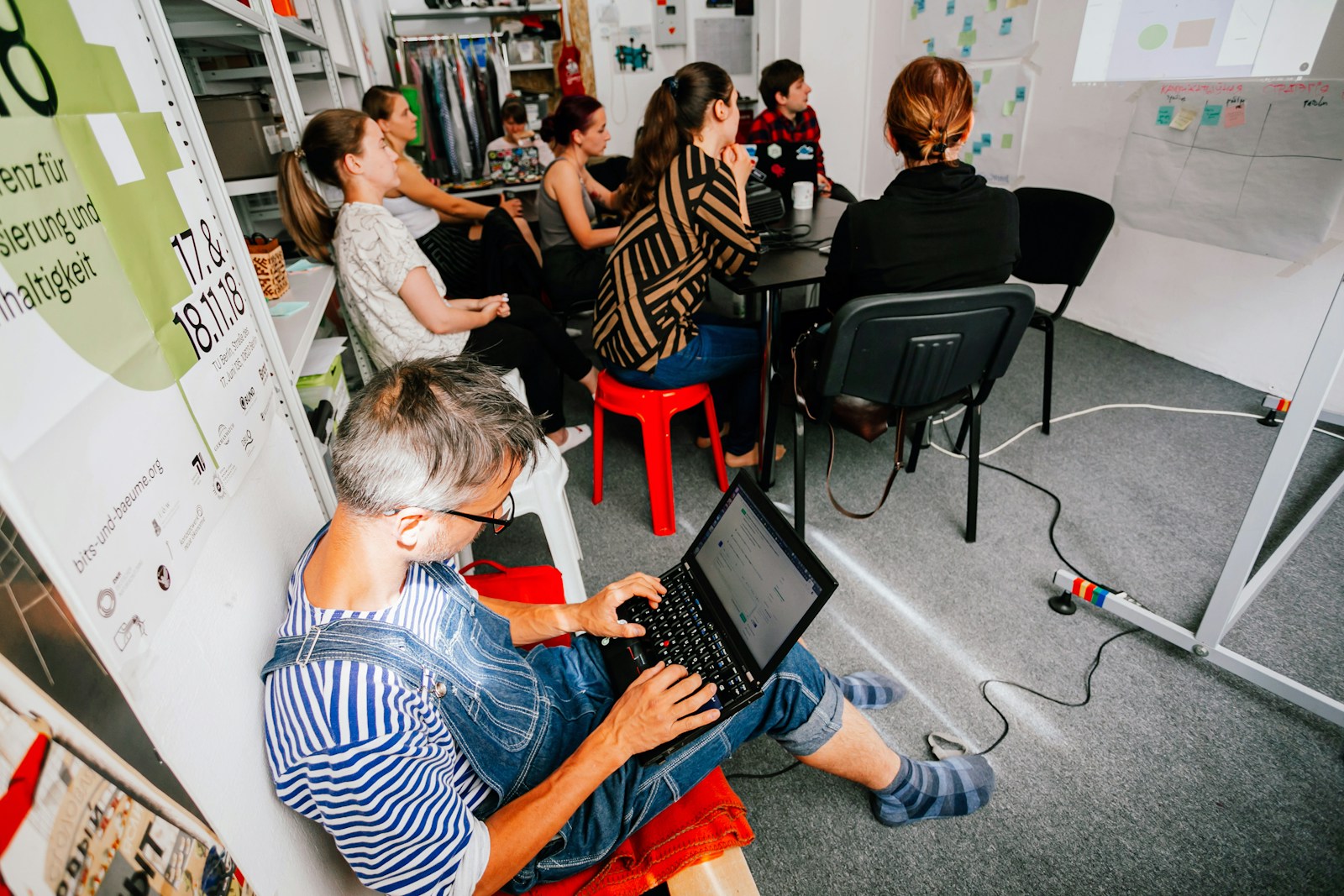 a man sitting in front of a laptop computer