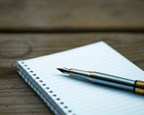 fountain pen on spiral book