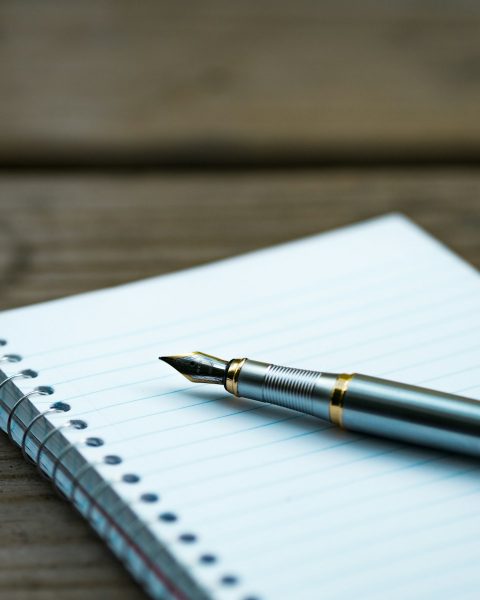 fountain pen on spiral book