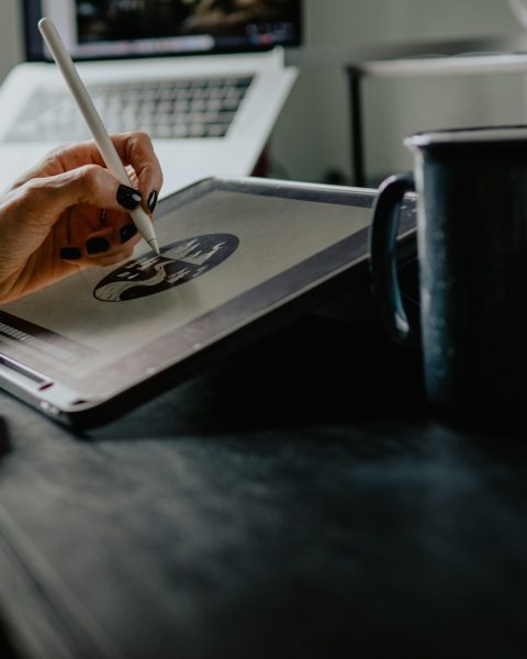 person holding silver fork on white paper