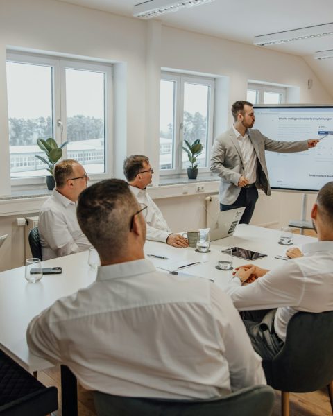 a man giving a presentation to a group of people