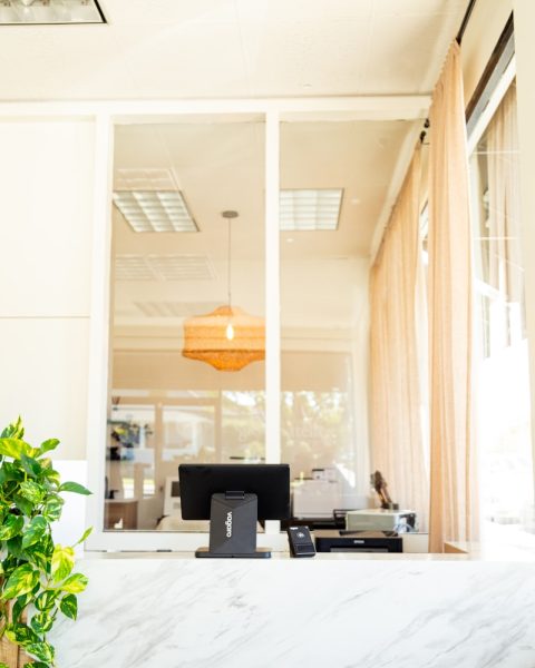 Reception desk with computer and printer.