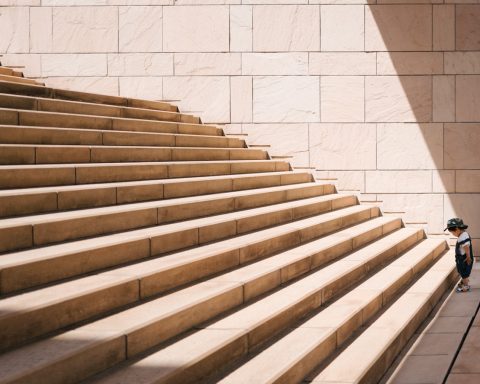 toddler's standing in front of beige concrete stair