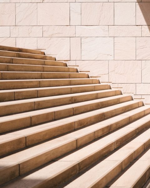 toddler's standing in front of beige concrete stair