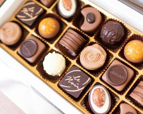 a box of assorted chocolates sitting on a table
