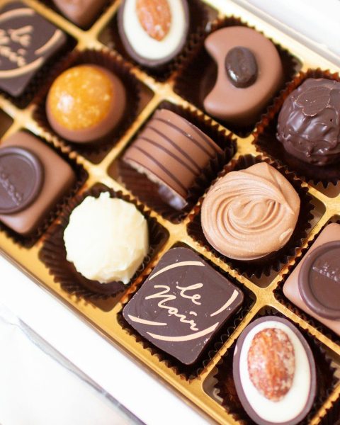 a box of assorted chocolates sitting on a table